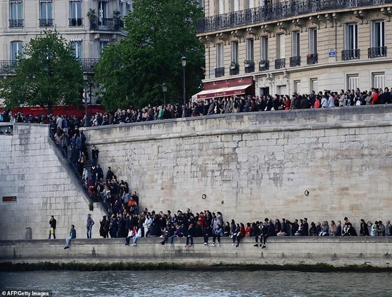 Người dân Paris quỳ gối cầu nguyện trước cảnh nhà thờ Đức Bà bị lửa thiêu rụi